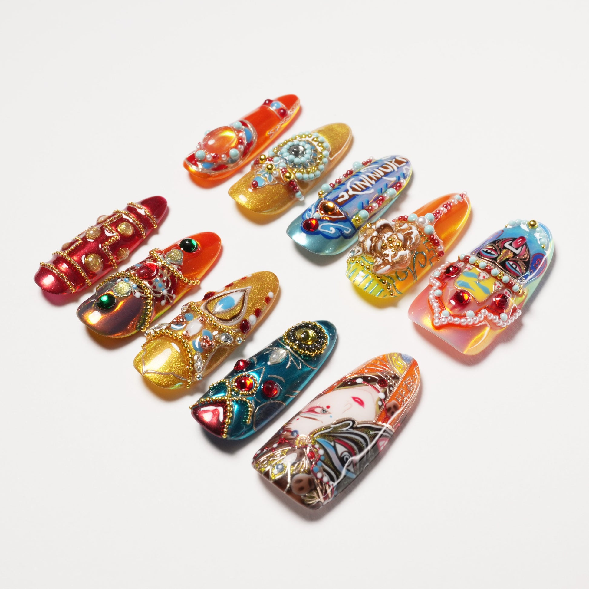 Set of colorful, intricately decorated artificial nails with beads, gems, and detailed art designs