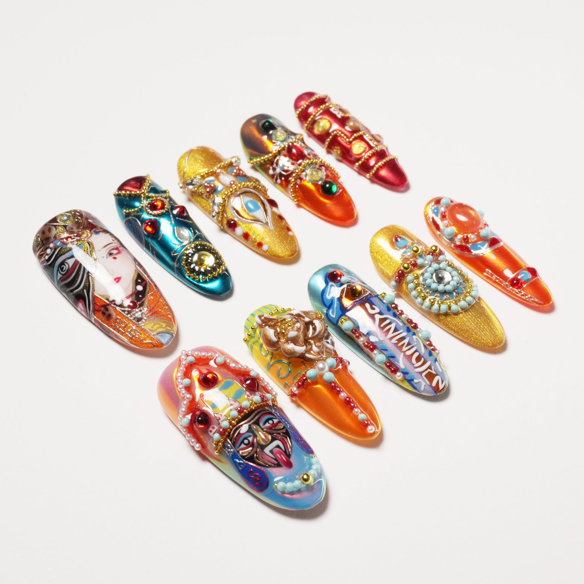 Intricate long acrylic nails with colorful 3D art, gems, beads, and cultural face designs