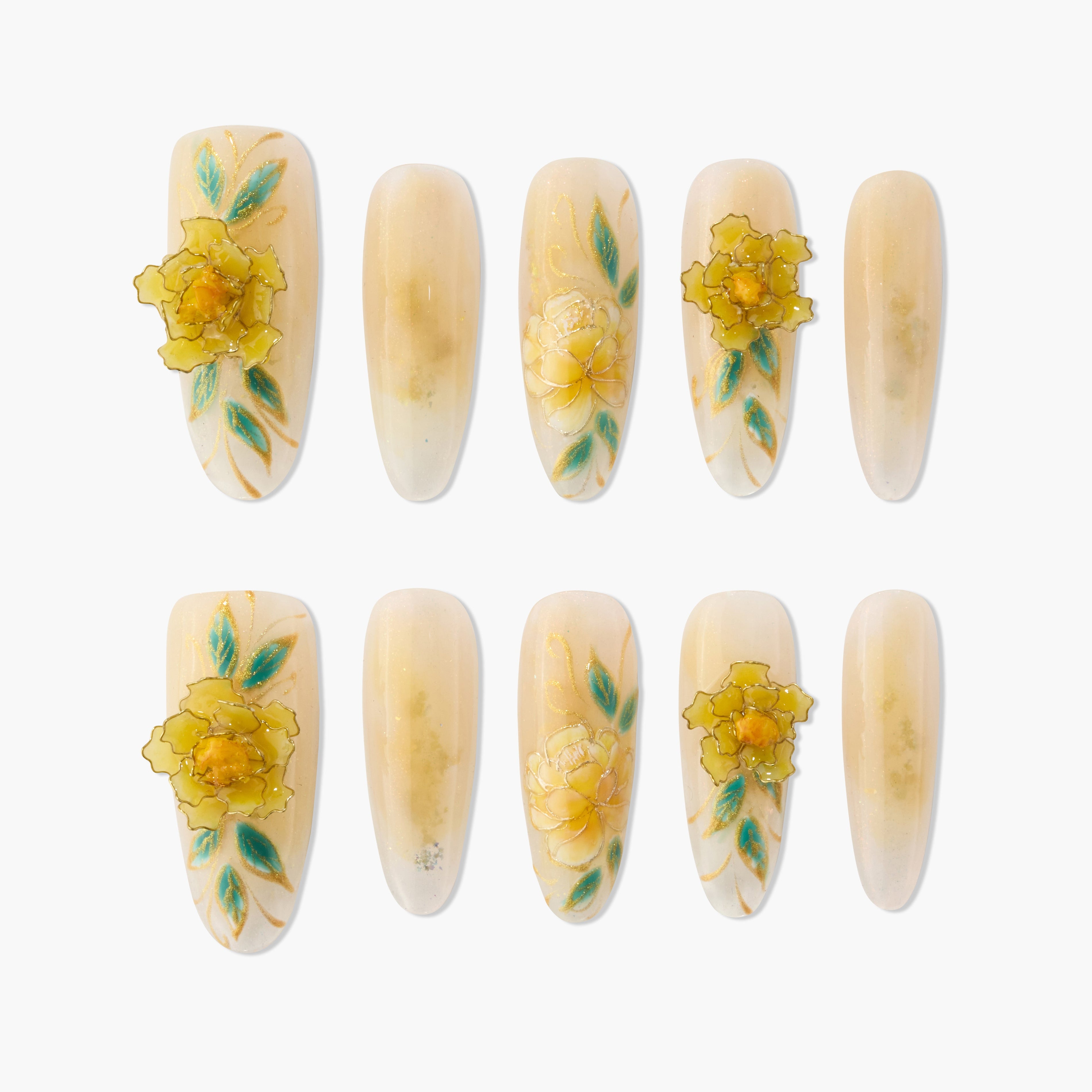 Set of beige press-on nails with yellow 3D floral designs and green leaves