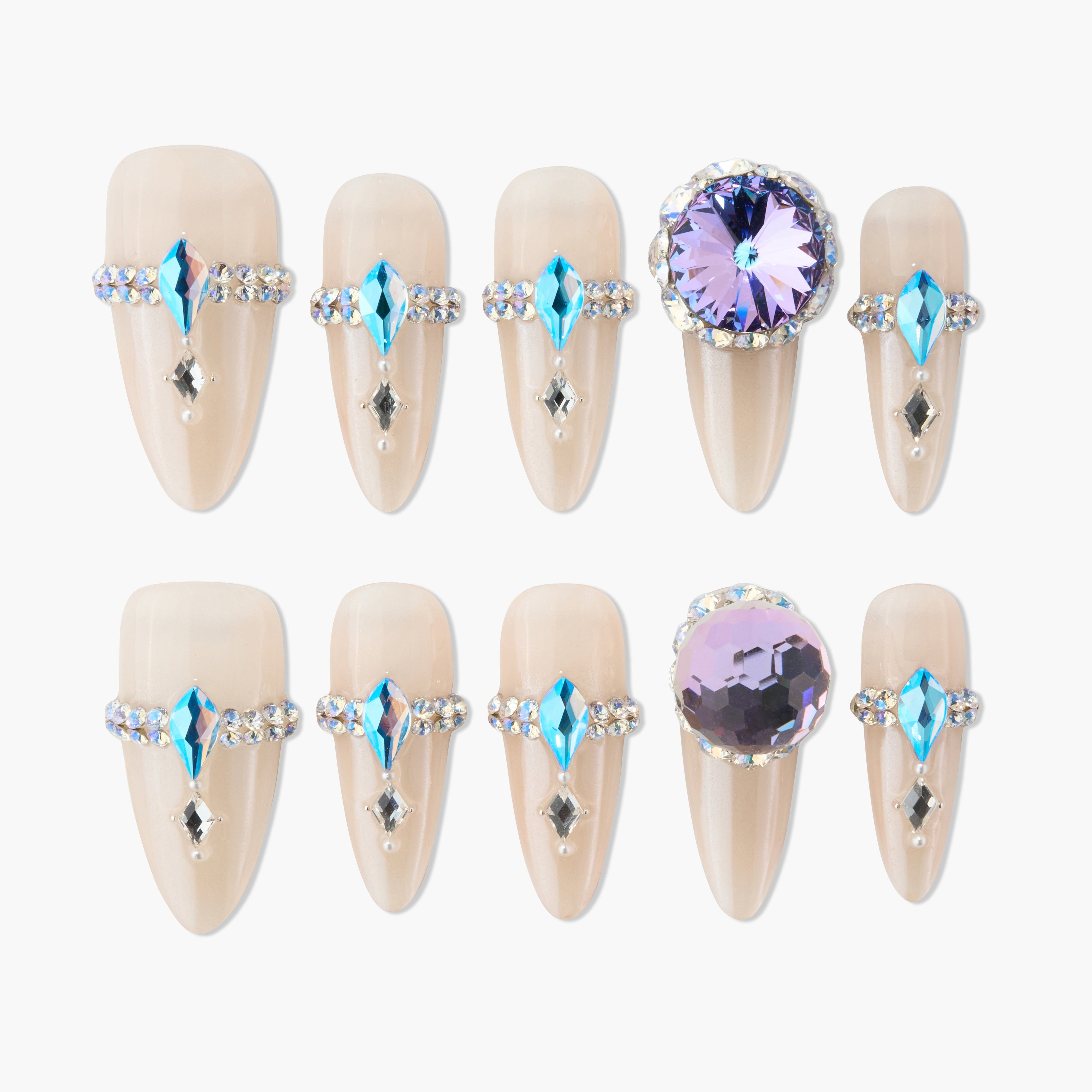 Set of nude press-on nails with blue and purple rhinestone embellishments for elegant nail art