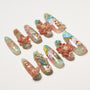 Set of decorative artificial nails with floral, fish, and 3D rose designs on pastel pink and teal bases