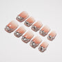 Handmade ombre press-on nails with silver glitter and rhinestone accents, arranged on white background.
