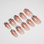 Handmade press-on nails with nude ombre base and 3D silver metallic tips
