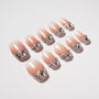 Handmade ombré press-on nails with silver glitter and gemstone accents on a white background