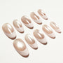 Oval-shaped nude and glitter gradient press-on nails displayed on white background