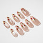 Handmade press-on nails with nude base, strawberry and daisy floral nail art design