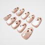 Handmade press-on nails with pearl finish and strawberry floral nail art design