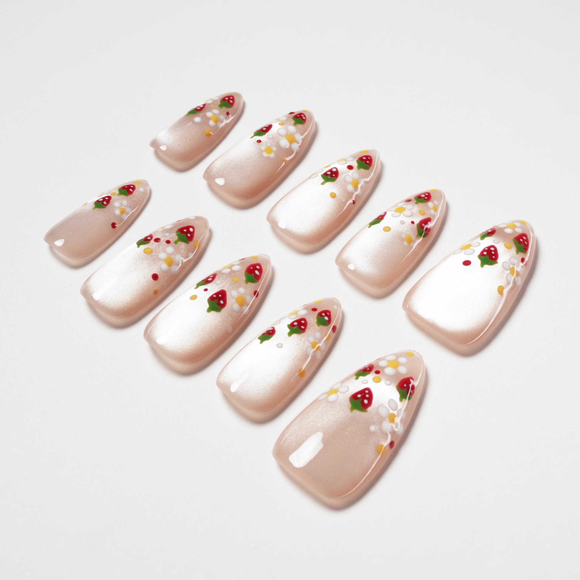 Handmade press-on nails with pearl finish and strawberry floral nail art design