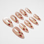 Almond-shaped press-on nails with strawberry and daisy floral nail art on nude base