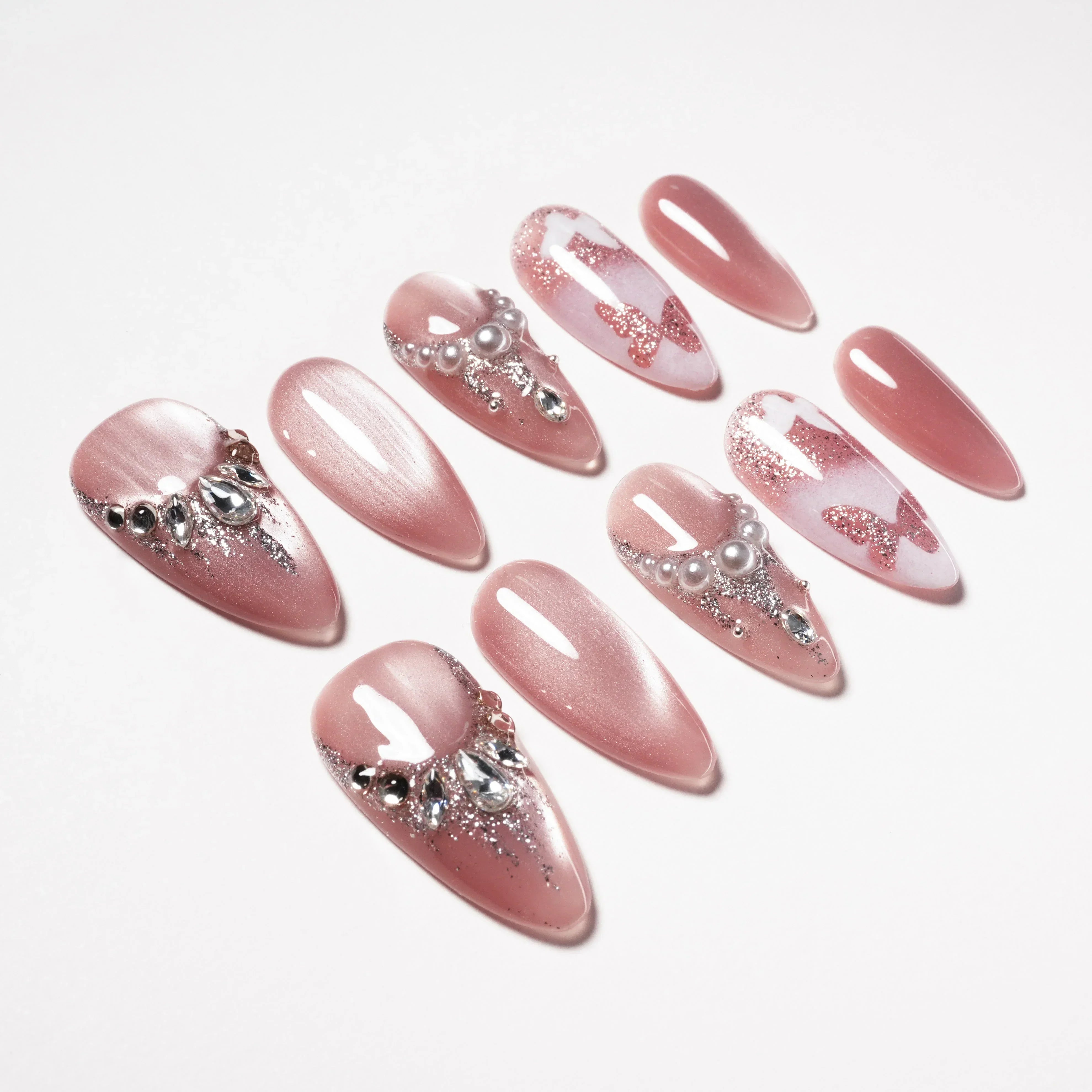 Close-up of Butterfly Whisper press-on nails with pearls and rhinestones