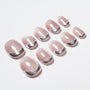 Set of pink and silver glitter press-on nails with a shiny, curved French tip design.
