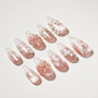 Handmade press-on nails with pink glitter base, white floral and 3D flower designs