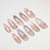 Set of long almond-shaped nude and mauve false nails with white floral and bow designs