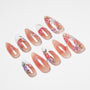 Handmade press-on nails with nude base, floral rose designs, white accents, and subtle glitter.