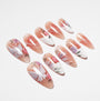 Handmade press-on nails with floral and butterfly design, nude and white base, glossy finish