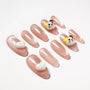 Pink press-on nails with glossy finish, decorated with 3D cat faces and white hearts