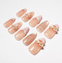 Handmade nude press-on nails with pink tips, polka dots, and 3D bow accents