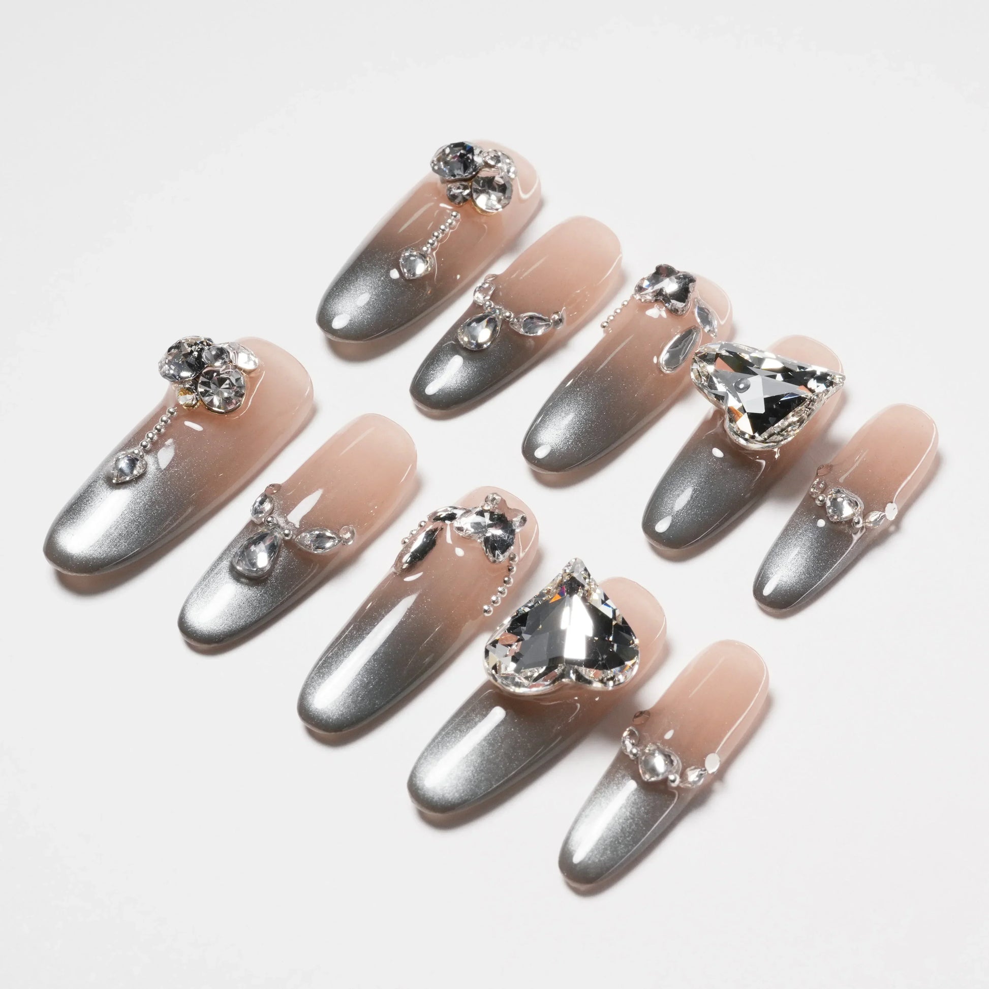 Set of elegant gray and nude ombre press-on nails with crystal and rhinestone embellishments