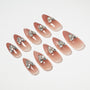 Almond-shaped nude ombre press-on nails with sparkling crystal rhinestone accents