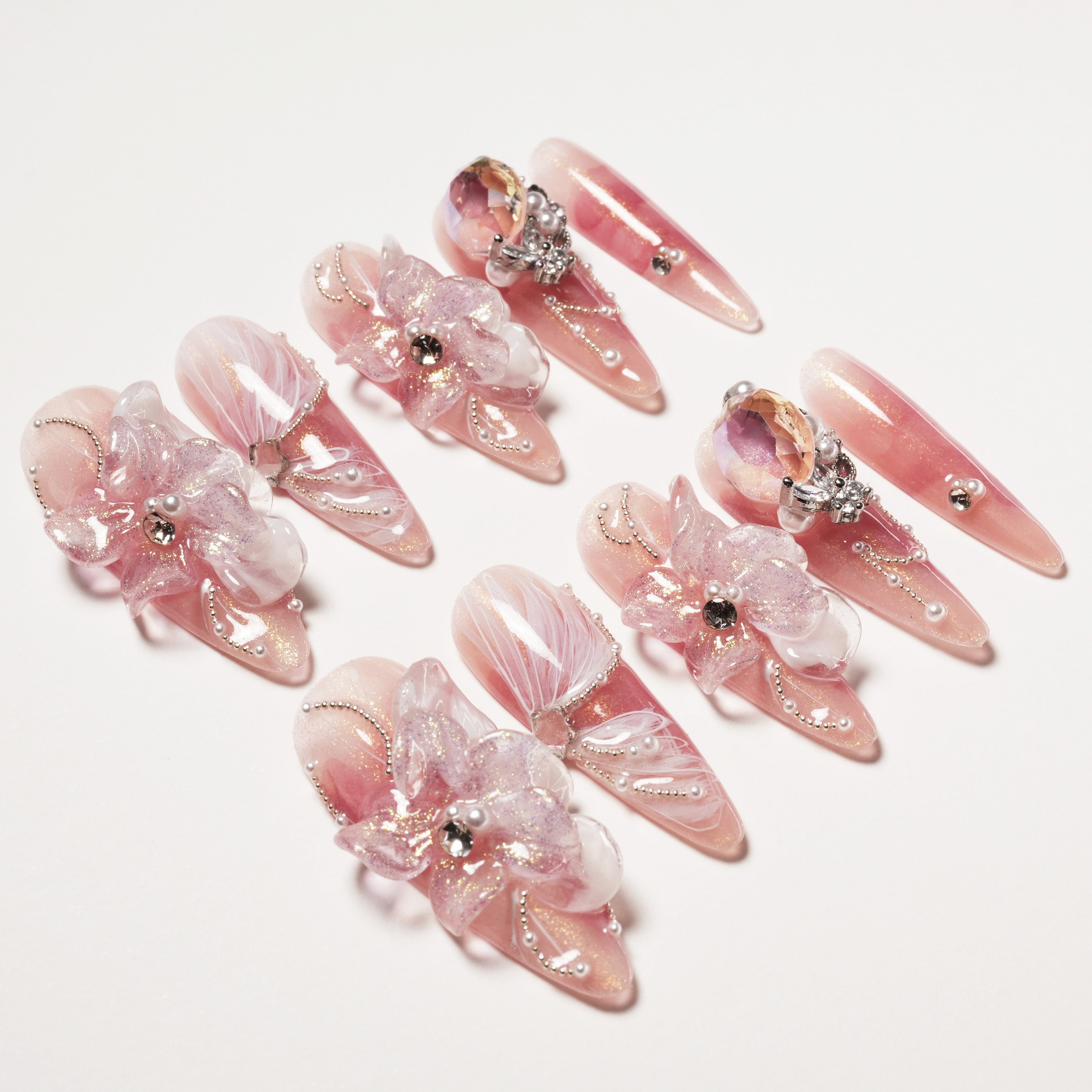 Set of elegant pink stiletto false nails with 3D floral decorations and rhinestones