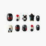 Handmade press-on nails with black, white, red designs and playful cartoon penguin art.