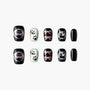 Set of black and glittery false nails with cute cat faces, paw prints, and pink bows nail art