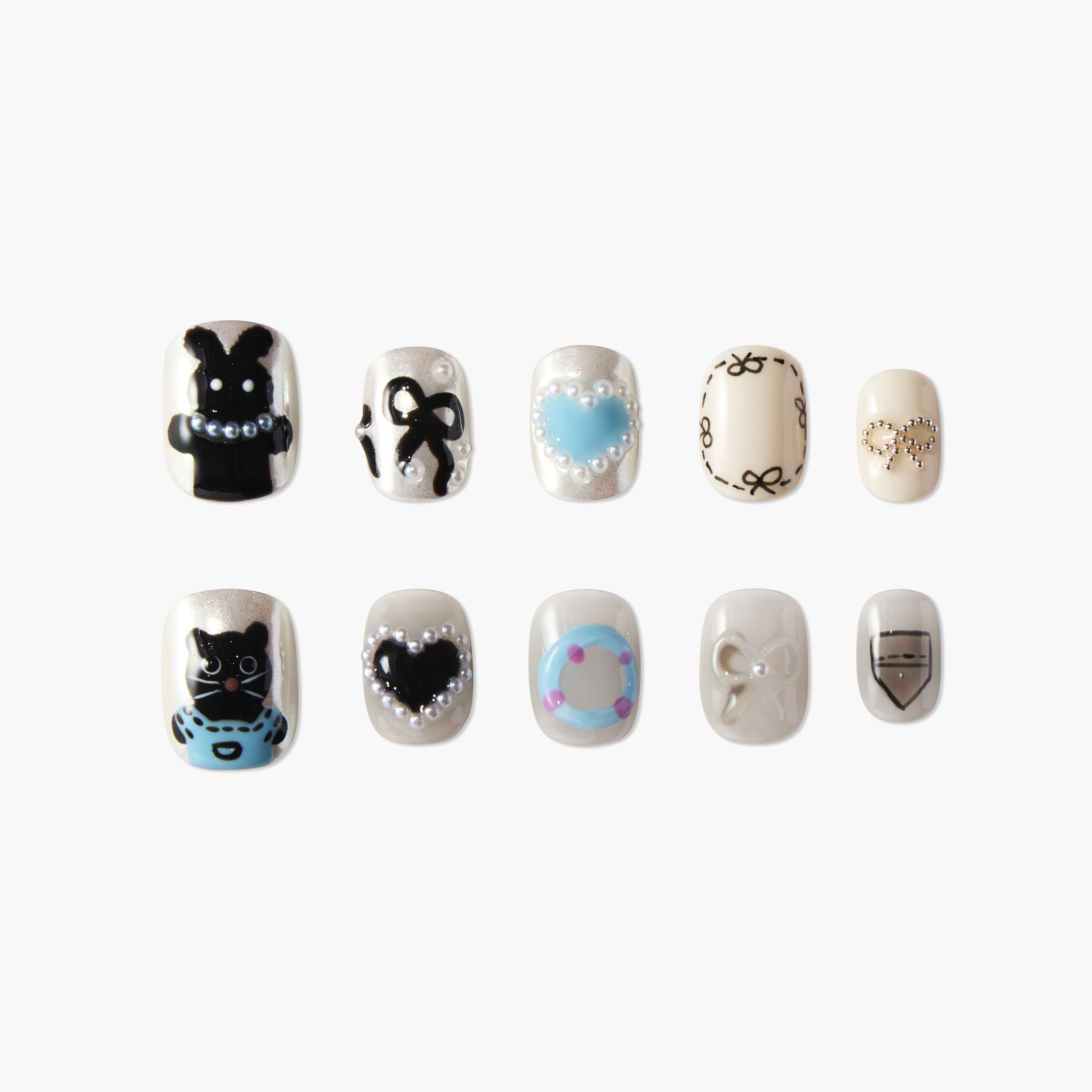 Set of 10 decorative artificial nails with black cat, bunny, hearts, bows, and blue accents on pearl base