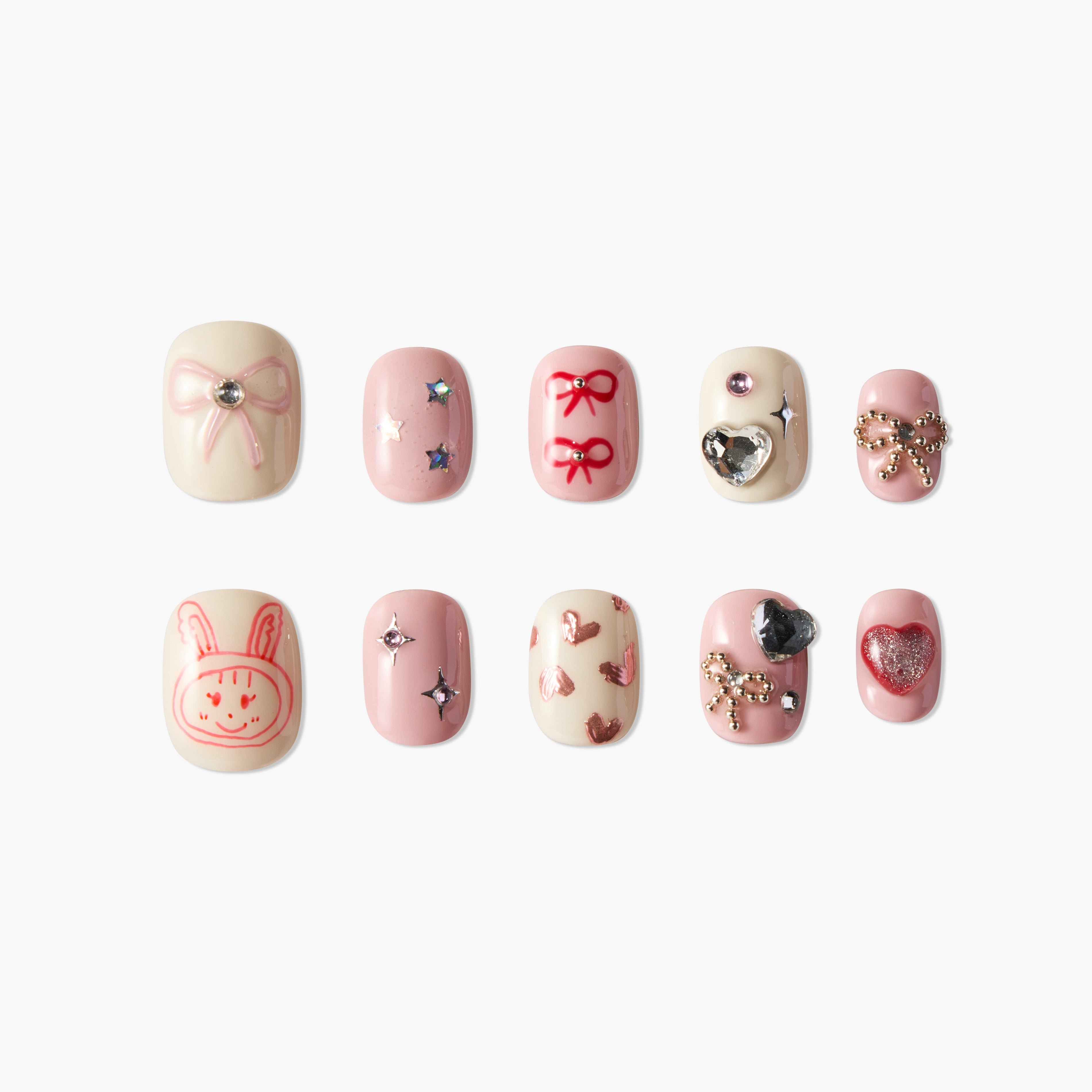 Set of 10 pink and cream artificial nails with bows, hearts, stars, and cute bunny designs
