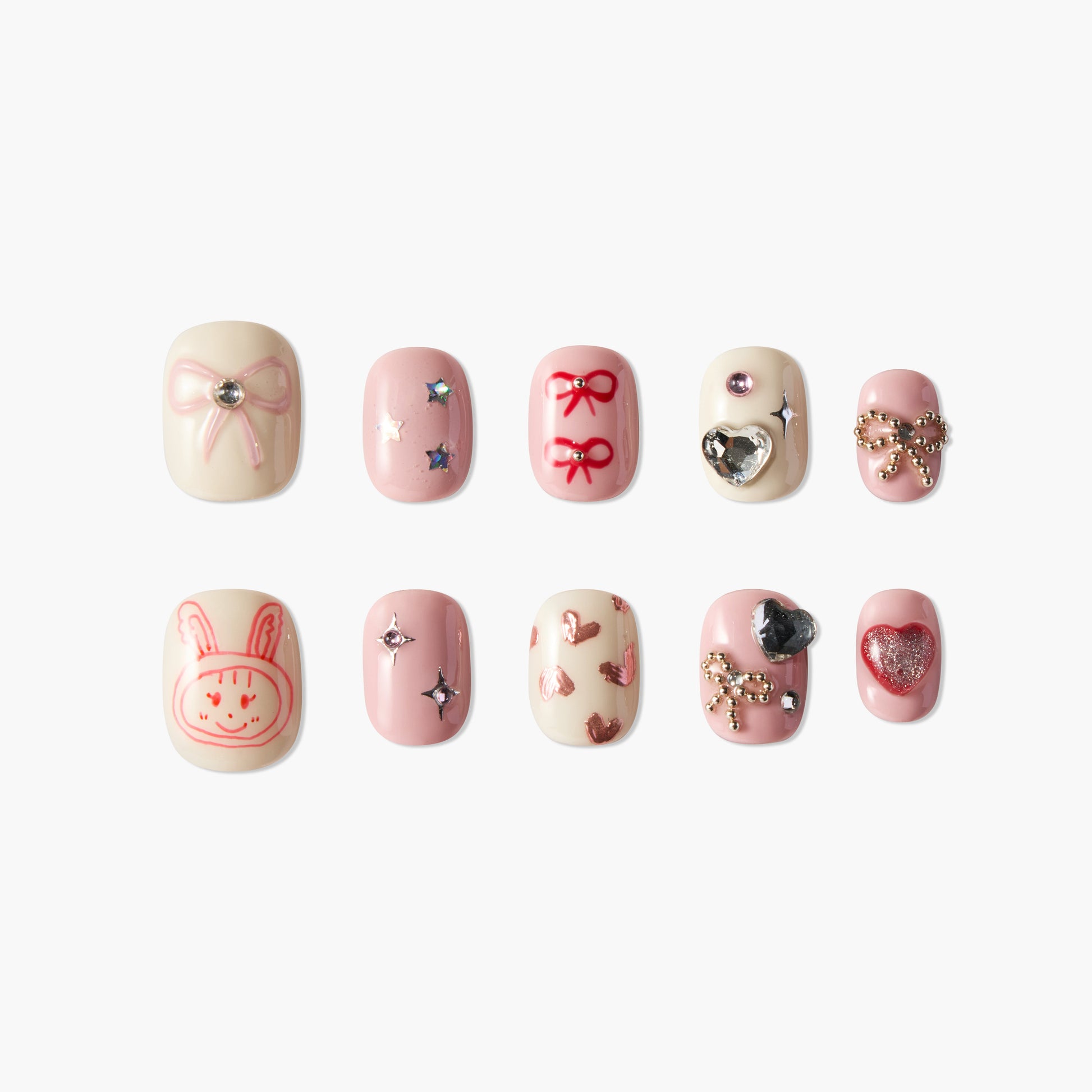 Set of 10 pink and cream artificial nails with bows, hearts, stars, and cute bunny designs