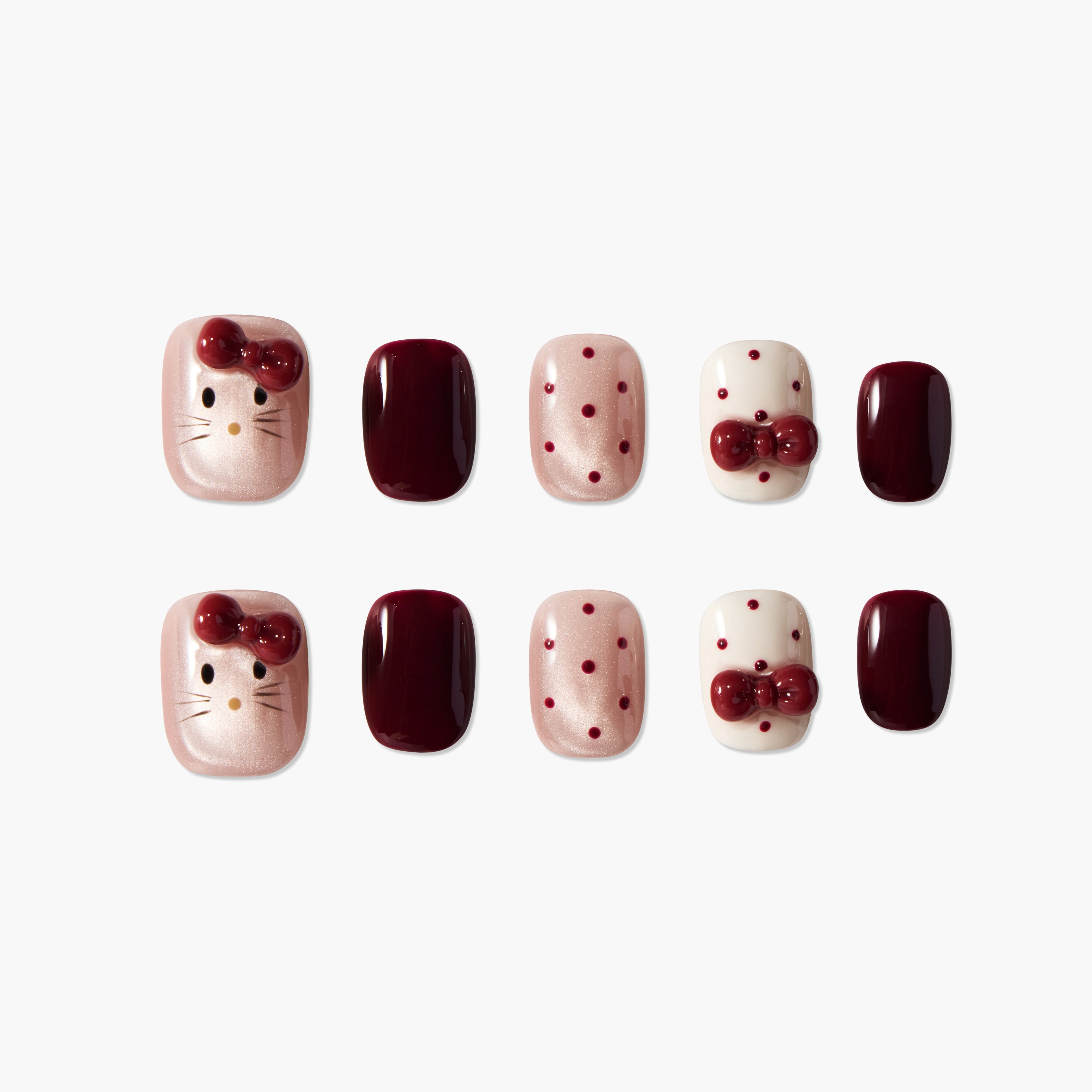 Set of decorative false nails with pink, burgundy, and white colors, featuring bow accents and cat face design
