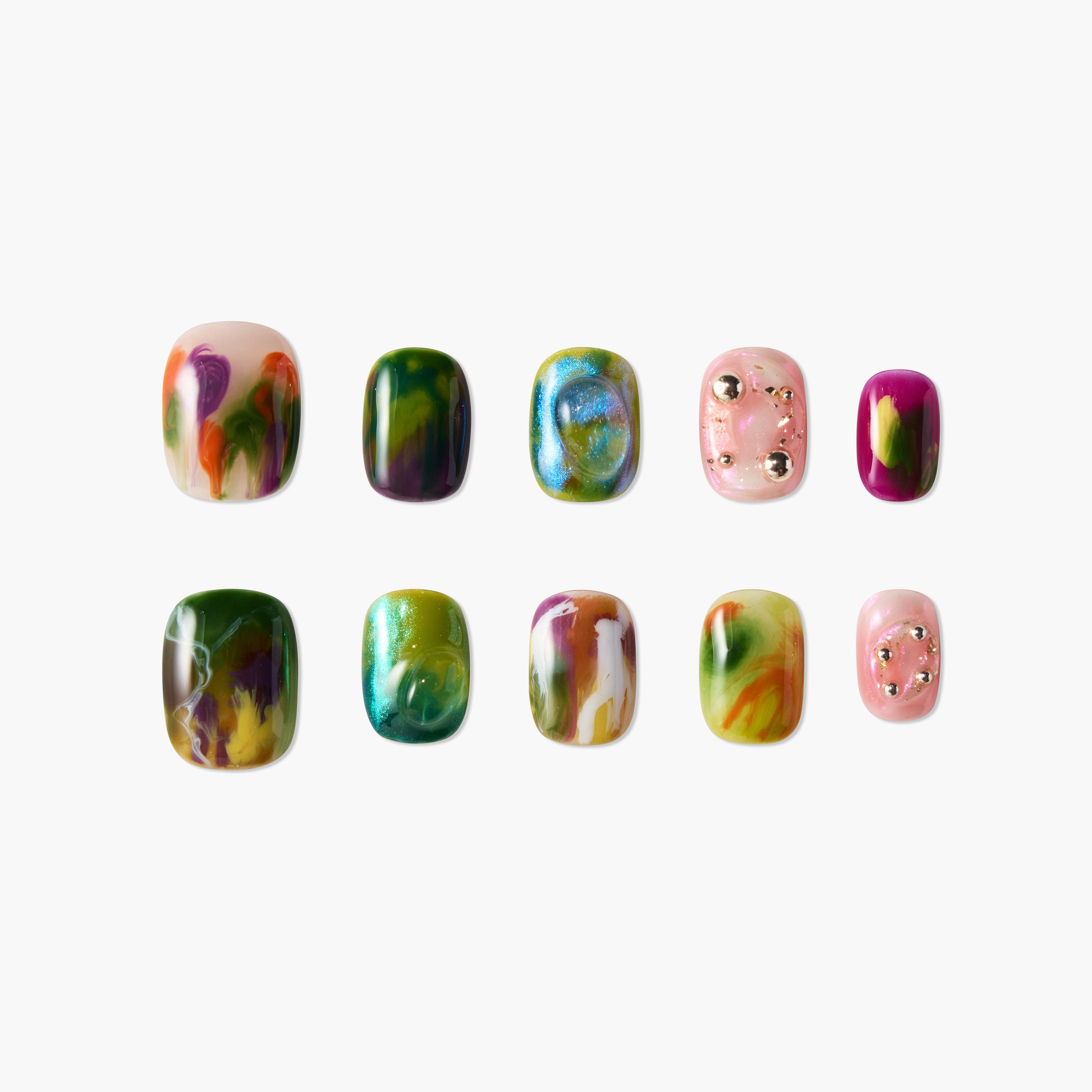 Set of ten colorful, glossy artificial nails with marble, shimmer, and stud designs on white background