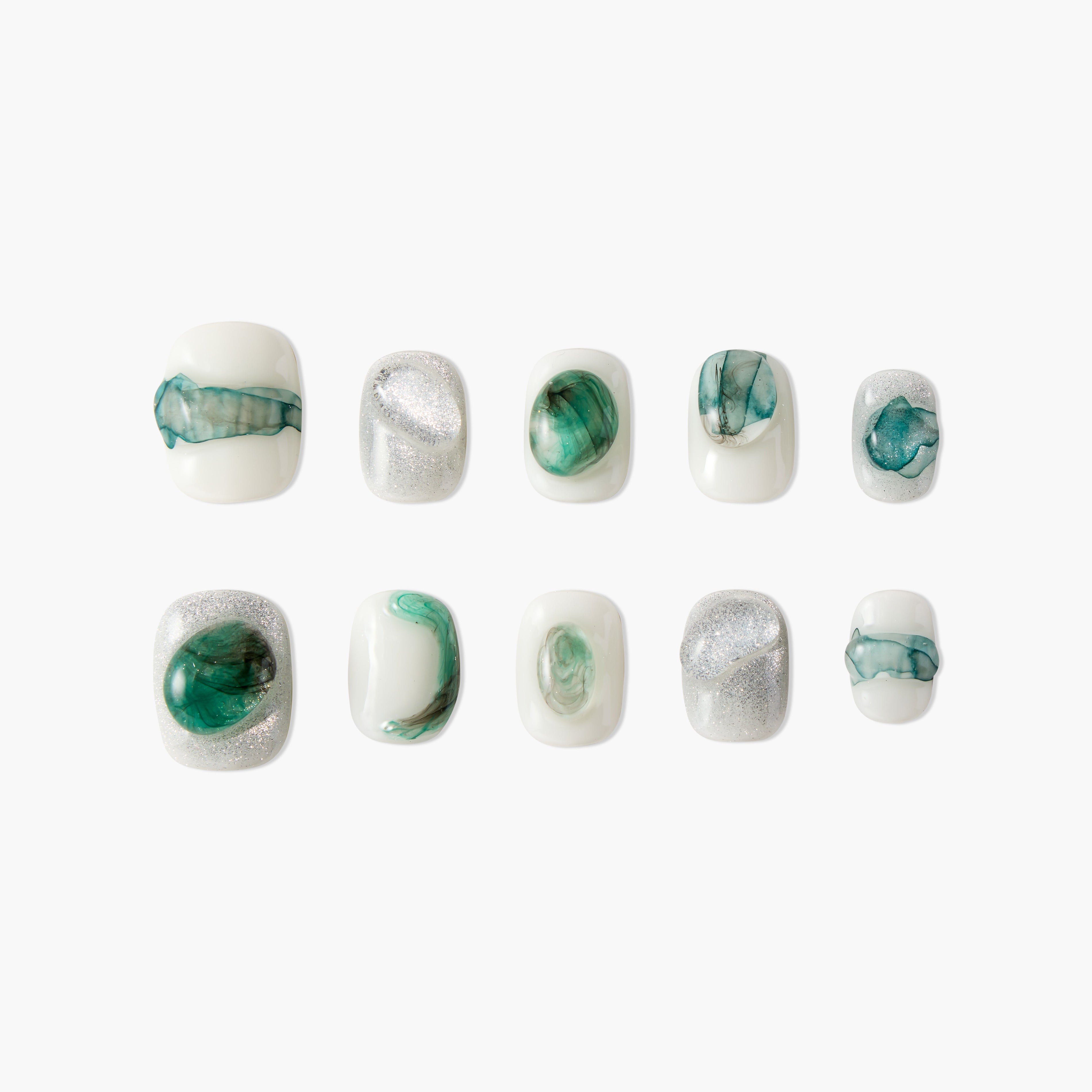 Set of white press-on nails with green marble and silver glitter designs on white background
