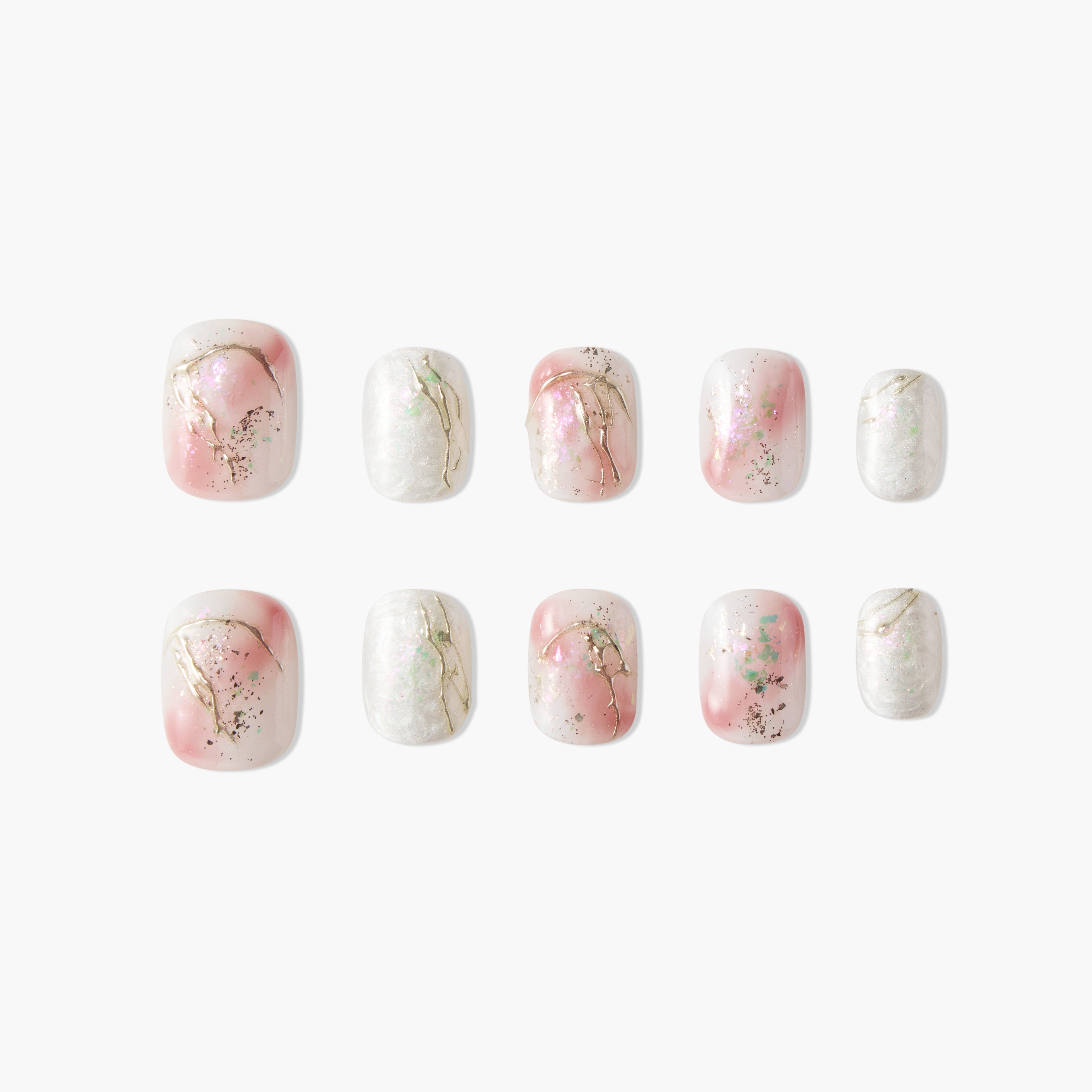 Set of pink and white marble effect press-on nails with gold accents and glitter on white background
