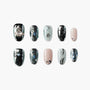 Handmade press-on nails set with metallic, black, silver, and pearl accents, celestial and heart designs