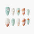 Set of 10 sea-inspired false nails with mint green, white, shell designs, pearls, and miniature seashell embellishments