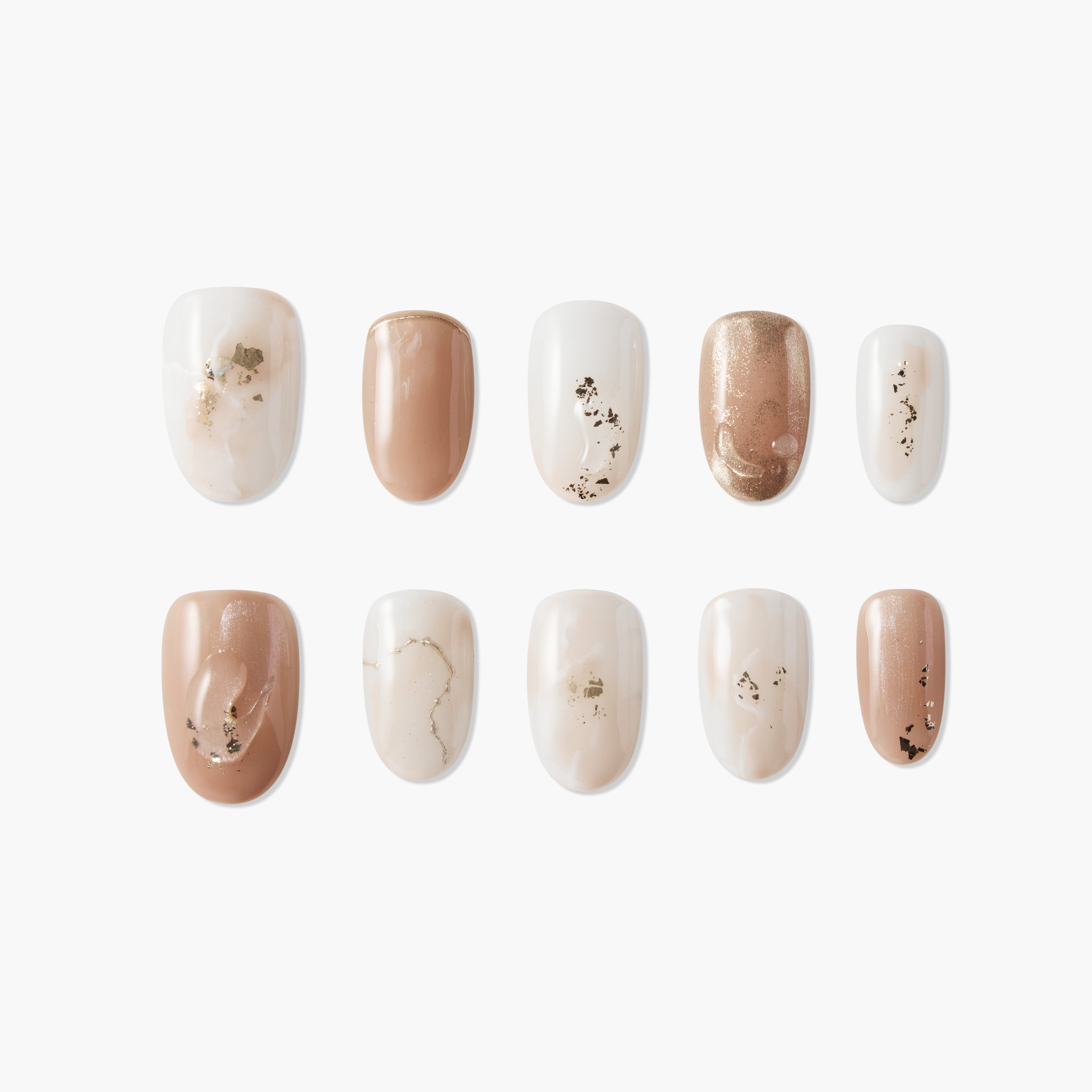 Set of artificial nails with nude, white, and gold foil designs on white background