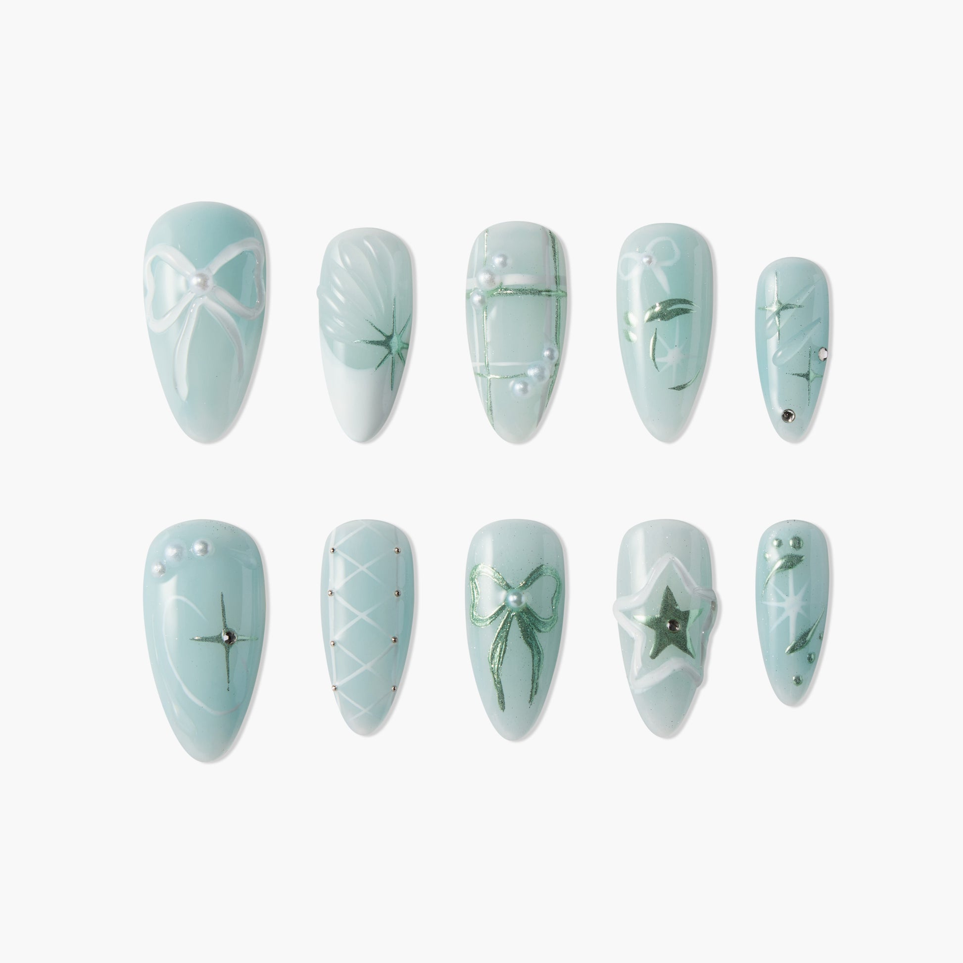 Light blue press-on nails with white bows, green accents, pearls, and star designs