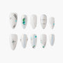 White press-on nails with pearl, silver, and turquoise stone accents, various elegant designs