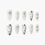 White and silver press-on nails with 3D bows, pearls, and cute bunny designs