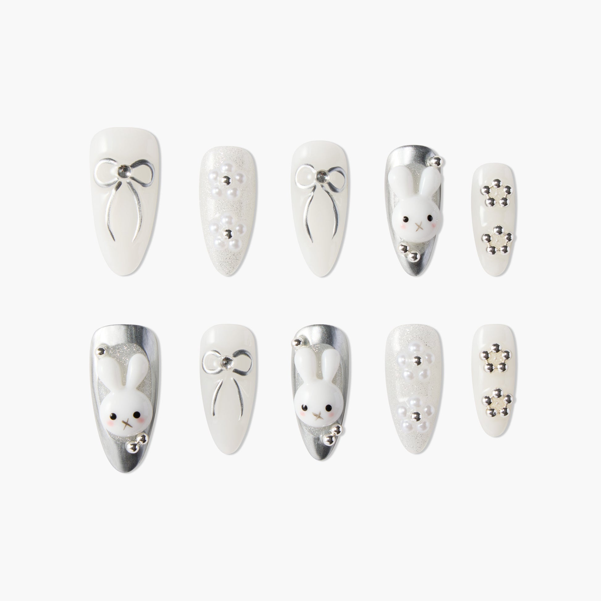 White and silver press-on nails with 3D bows, pearls, and cute bunny designs