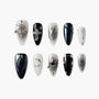 Set of black and white artificial nails with silver 3D stars, crosses, and abstract designs