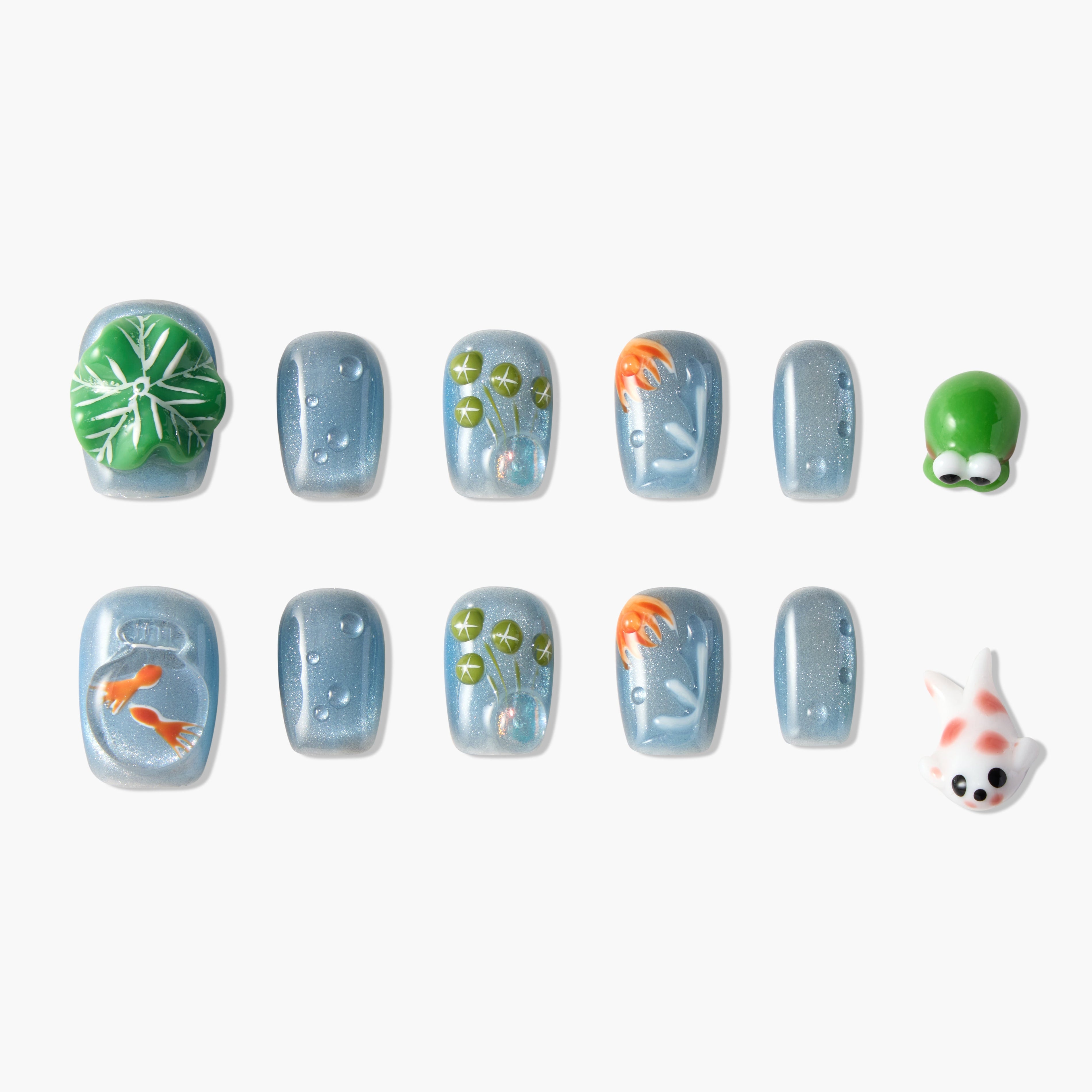 Set of blue glittery press-on nails with 3D koi fish, lily pads, and frog designs on white background