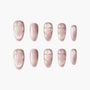 Set of shimmery pink press-on nails with embossed heart designs on white background
