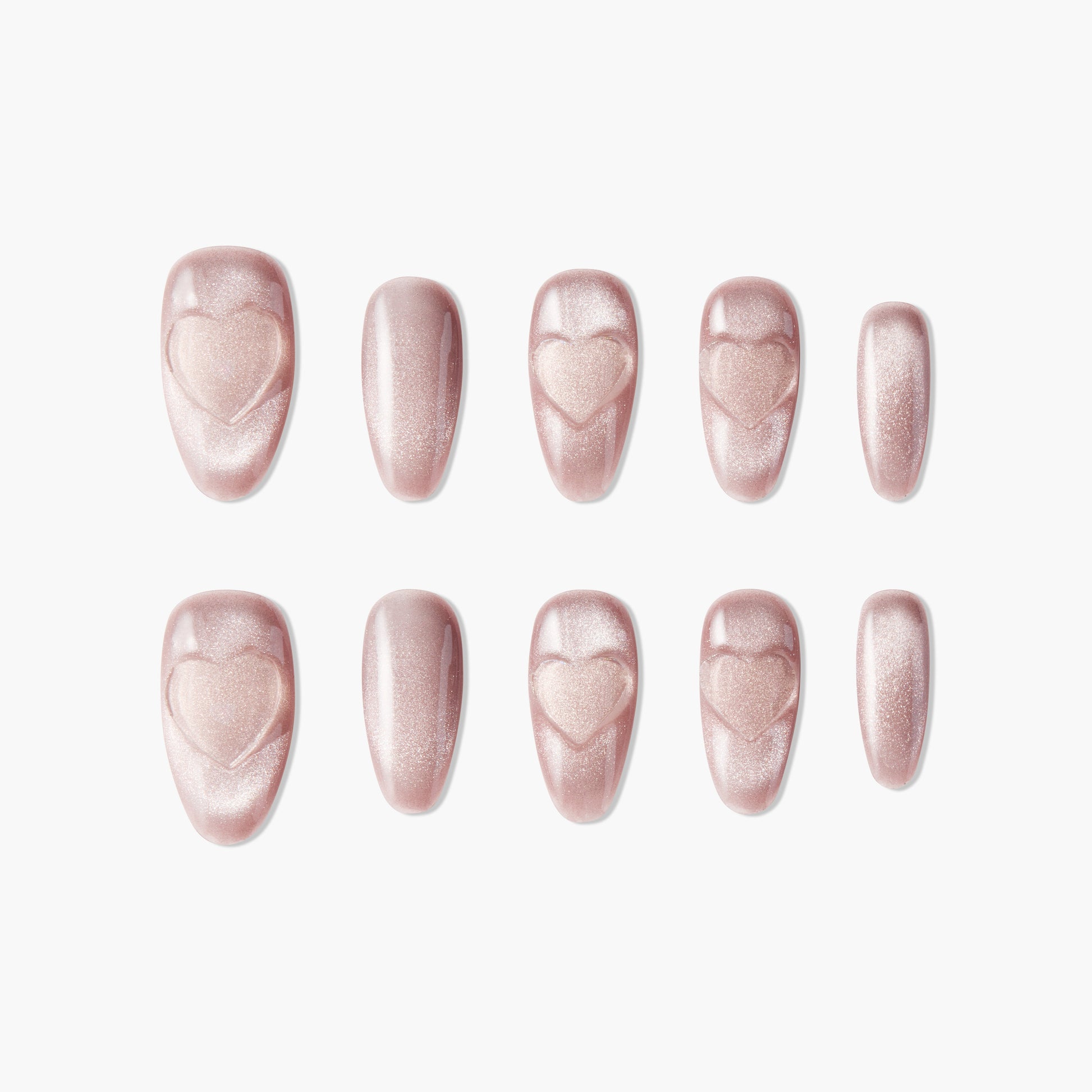 Set of shimmery pink press-on nails with embossed heart designs on white background