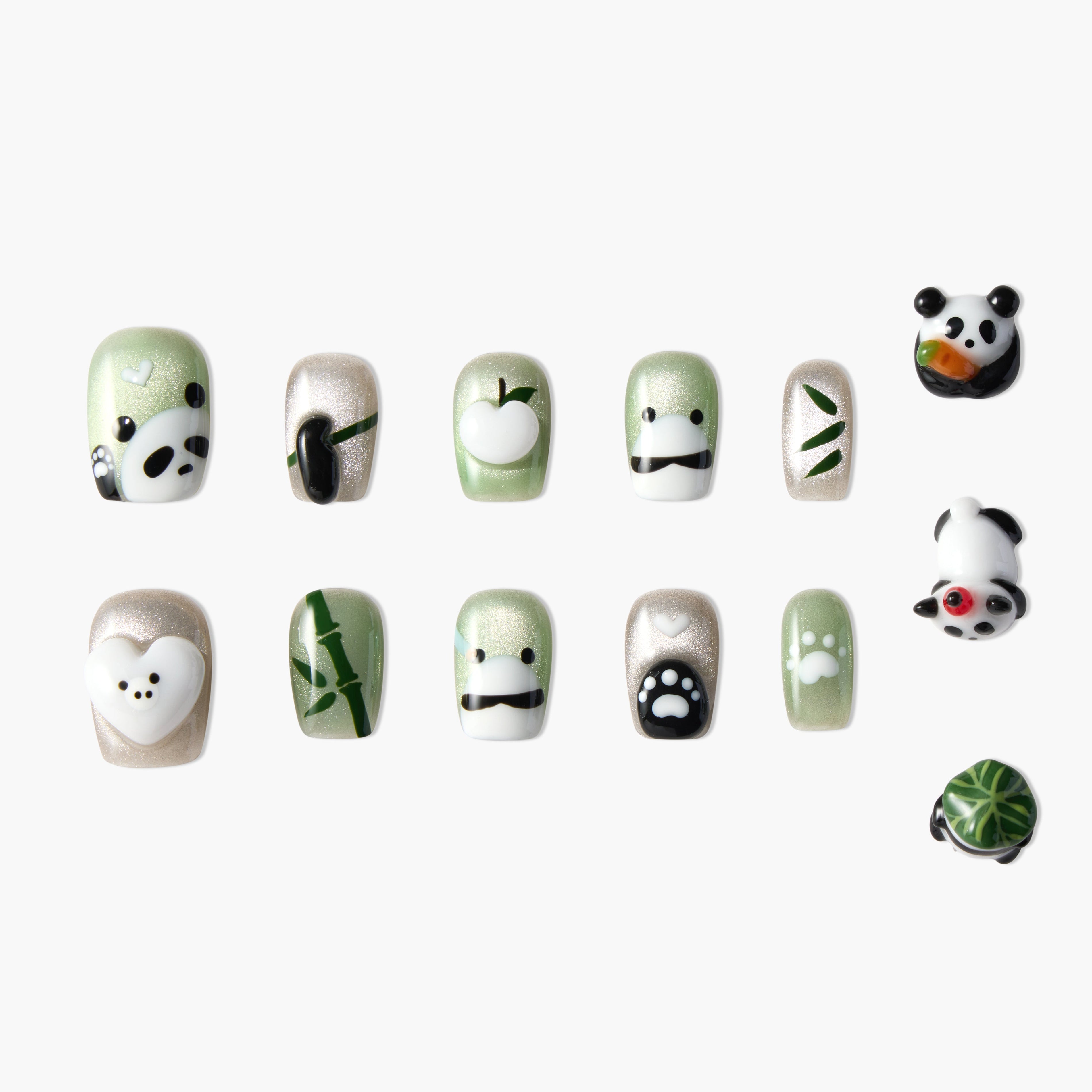 Set of green and beige shimmery press-on nails with panda, bamboo, apple, and paw print designs
