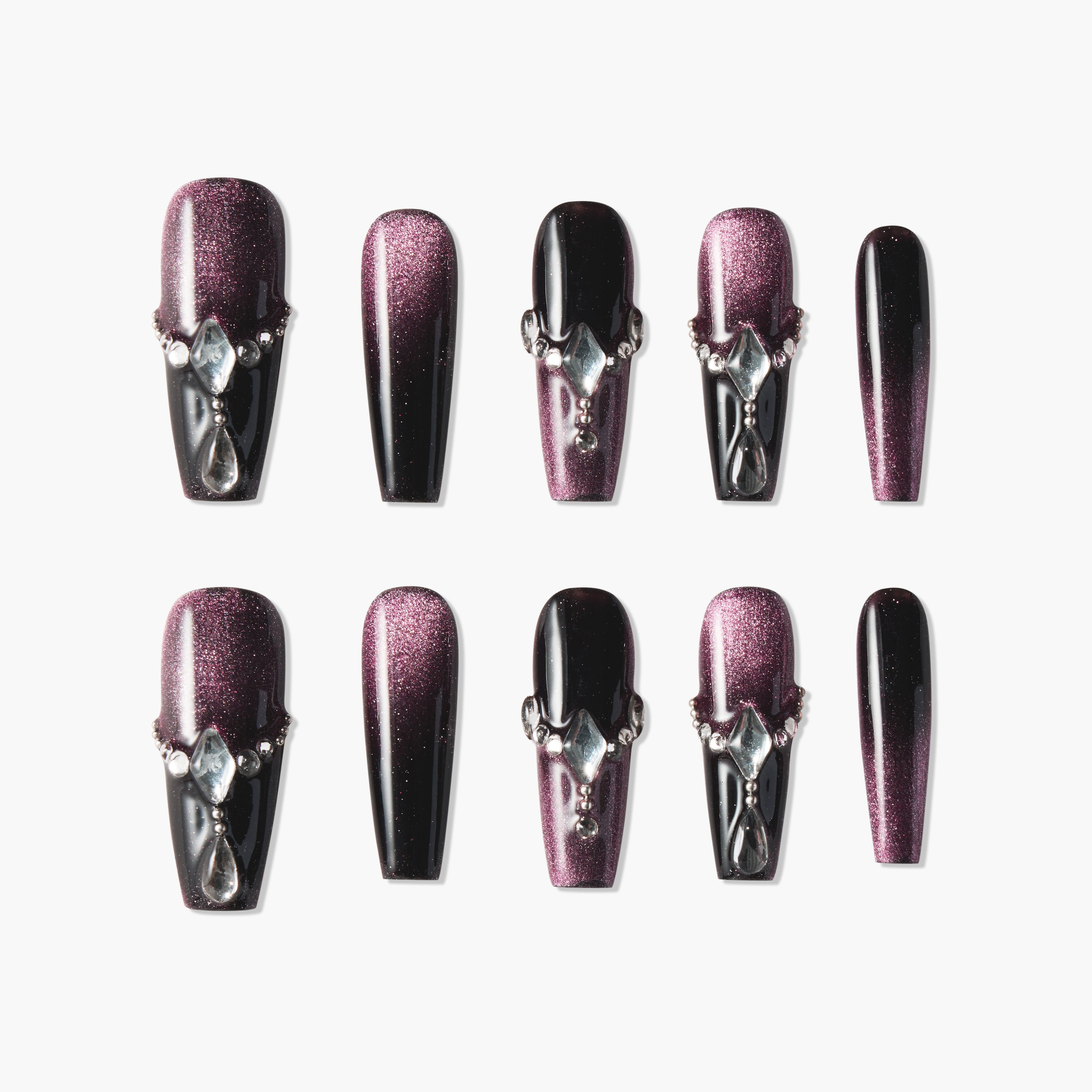 Set of black and purple ombre press-on nails with rhinestone embellishments on a white background