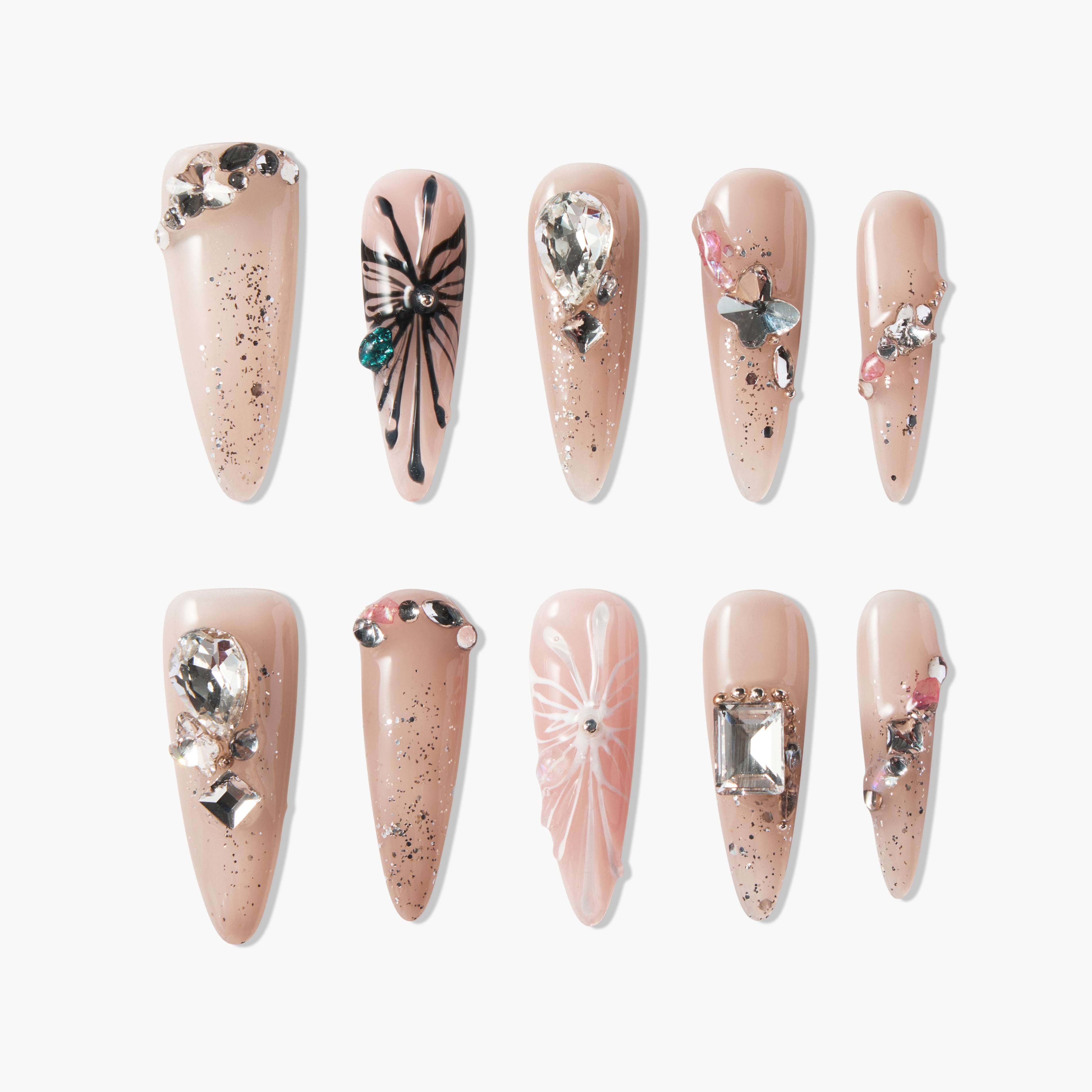 Set of nude long fake nails with glitter, black and white butterfly designs, and rhinestone embellishments