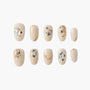 Beige press-on nails with gold marbling and black glitter accents, displayed on white background.