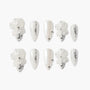 White press-on nails with 3D floral accents, silver glitter details, and pearl embellishments.