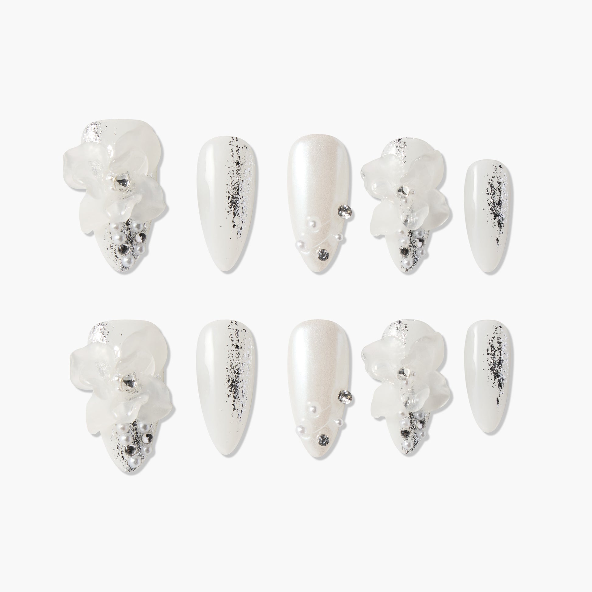 White press-on nails with 3D floral accents, silver glitter details, and pearl embellishments.